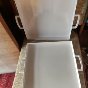 VINTAGE TWO WHITE HARD PLASTIC TRAYS WITH HANDLES.